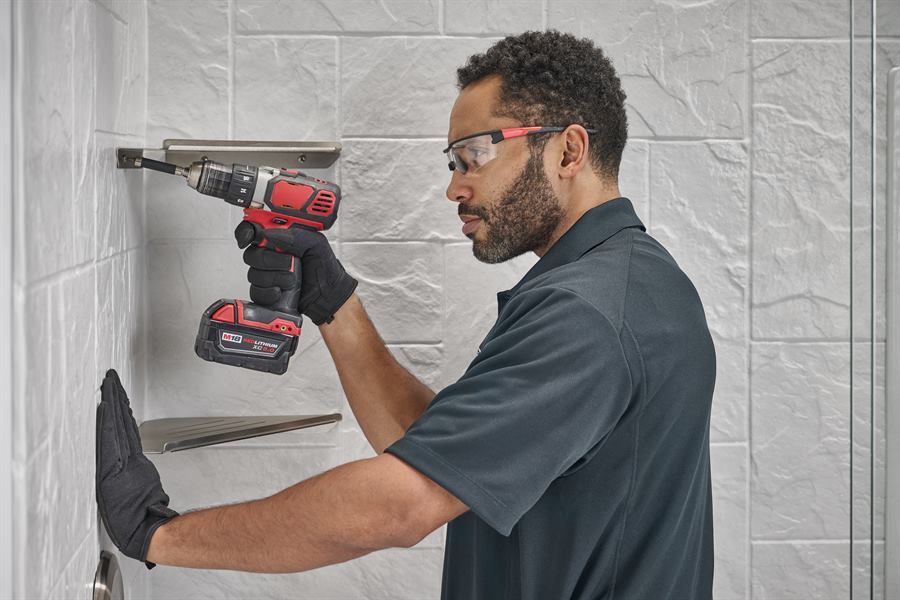 Jacuzzi Bath Remodel installer mounting a shower shelf