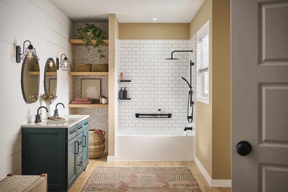 Bathtub with white subway tile walls and wall-mounted support bar within easy reach